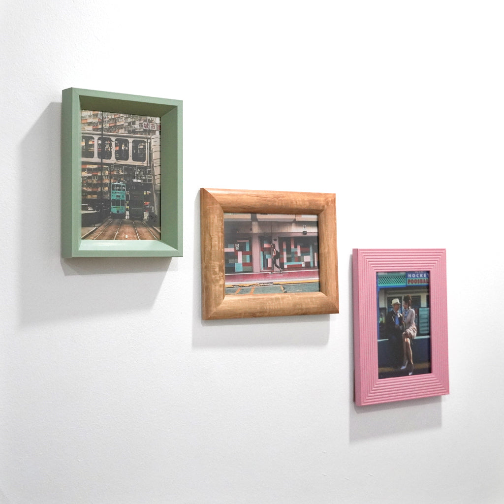 Assorted quirky eclectic 4r and 5r photo frames with fun picture on wall and can be placed on table