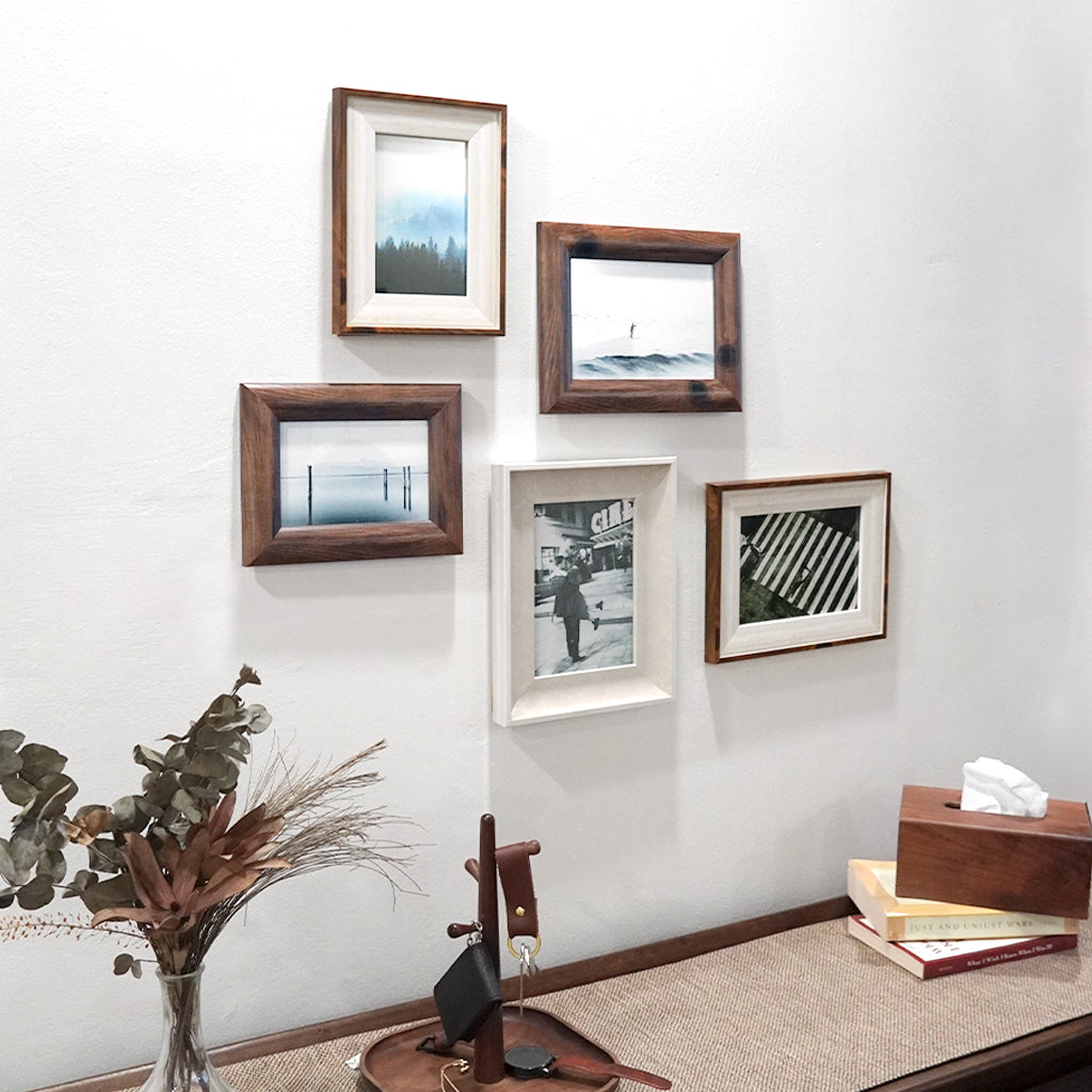 Various modern minimalistic wood mid century 4r and 5r photo frames with cherished picture on wall and can be placed on table