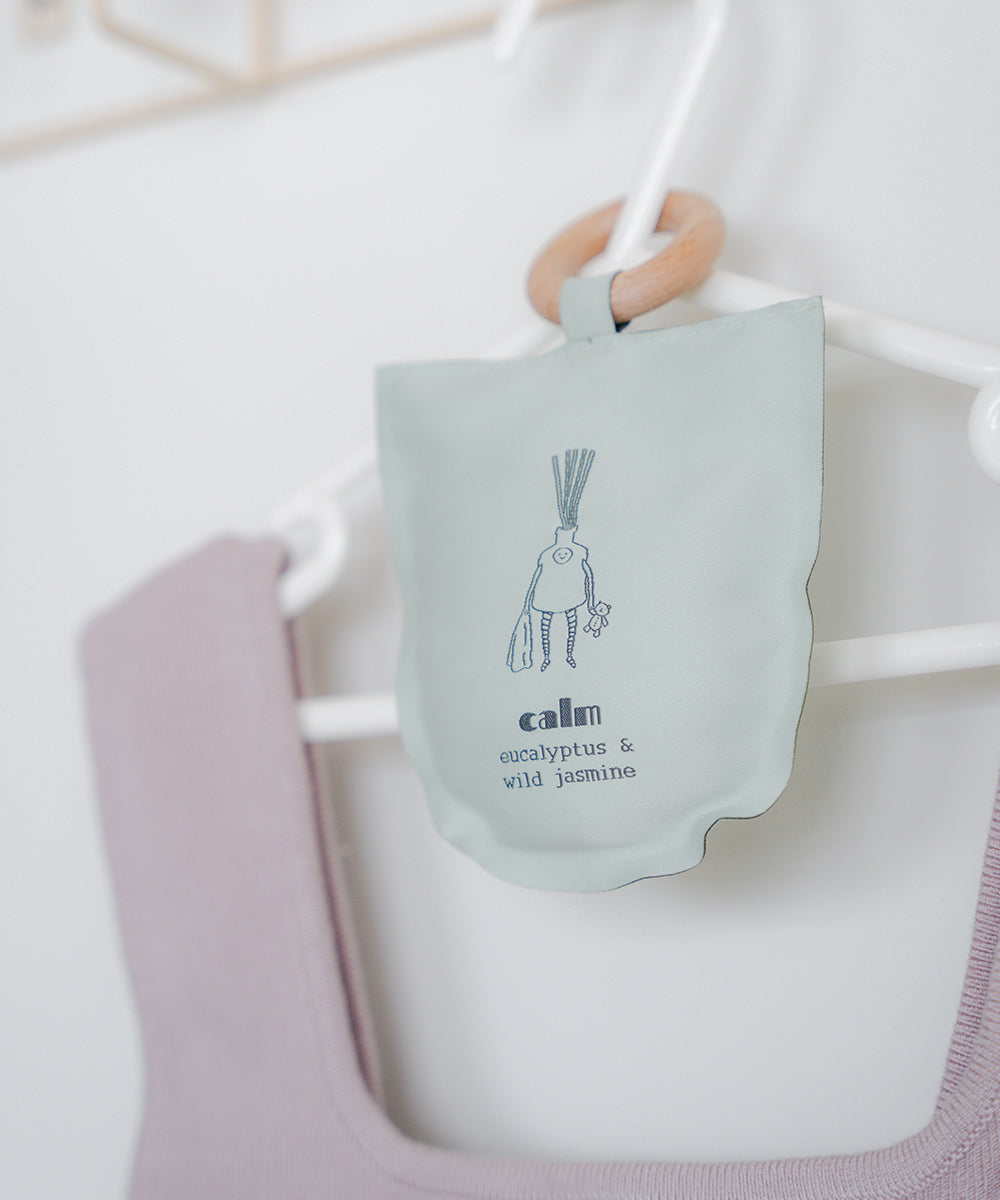 scented sachet hanging on hanger with clothes